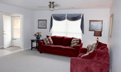 Bright living room with red couches and decor