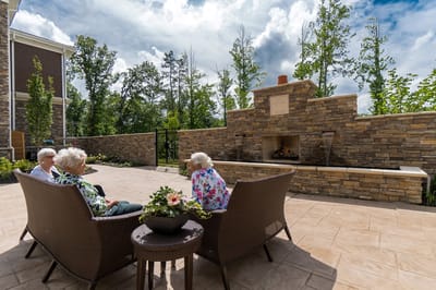 Residents enjoying a sunny outdoor seating area