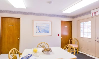 Dining area with table, food, and drink setup