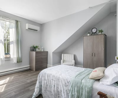 Bright, well-furnished bedroom in a senior living facility