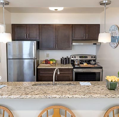 Modern kitchen setup with appliances and fruit.