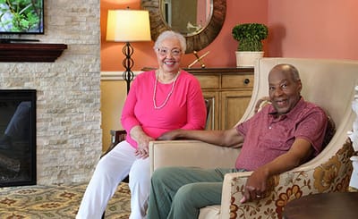 Two residents enjoying time in a cozy common area