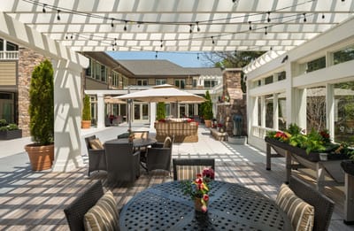 Outdoor patio area with seating and greenery