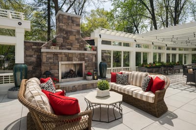 Outdoor lounge area with comfortable seating and fireplace