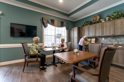Two residents chatting in a cozy common area