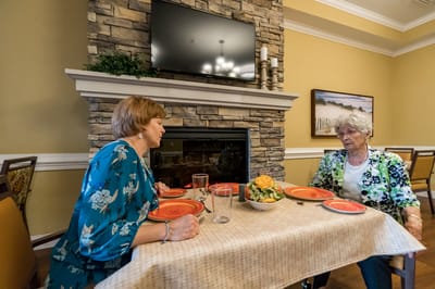 Two residents having a meal in a dining area