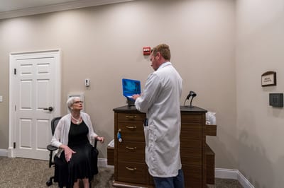 A staff member interacting with a resident in a facility interior