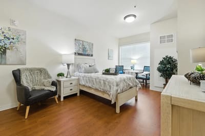 Cozy private resident room with a bed and seating area