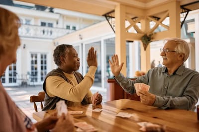 Residents playing cards in a cozy indoor space