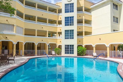 Outdoor pool area with building in the background