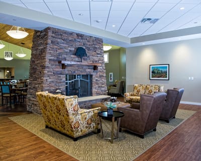 Interior common area with comfortable seating and stone fireplace