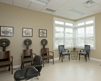 Hair salon area with seating and hair dryers