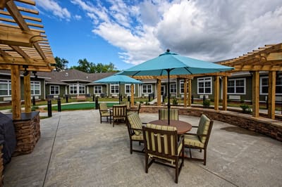 Outdoor seating area with umbrellas and landscaping