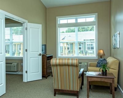 Cozy resident room with a chair and a lamp