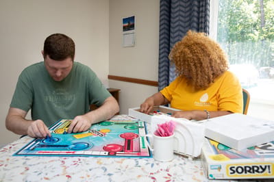 Residents playing a board game in a common area