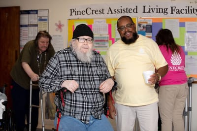Residents and staff in a communal area of the facility
