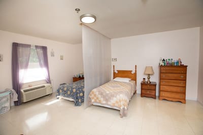 Private resident room with twin beds and chest of drawers