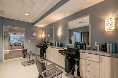 Bright salon area with styling chairs and products
