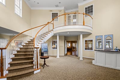 Bright interior lobby with a curved staircase