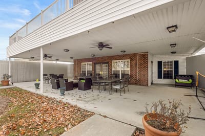 Covered outdoor seating area with tables and chairs