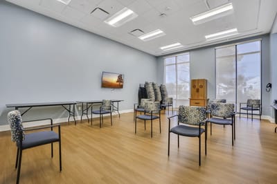 Bright activity room setup with chairs and tables
