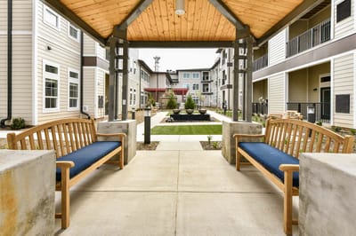 Outdoor seating area with benches and landscaped garden
