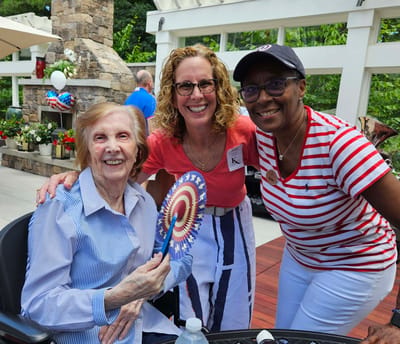 Residents enjoying an outdoor celebration with staff