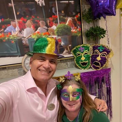 Two staff members celebrating in a festive interior