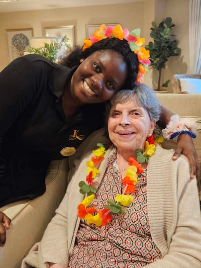 Staff member with a resident celebrating together