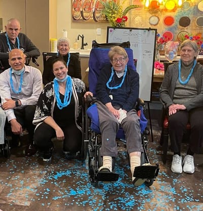 Residents and staff enjoying an activity together indoors