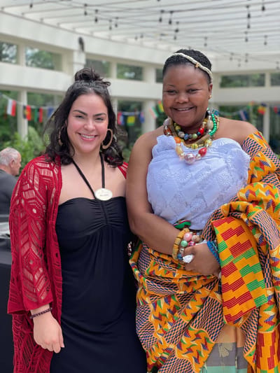 Two women in cultural attire at an event