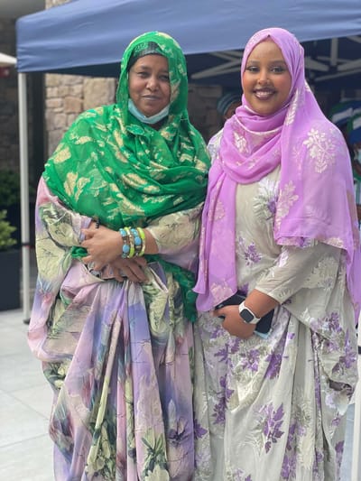 Two women dressed in colorful traditional attire