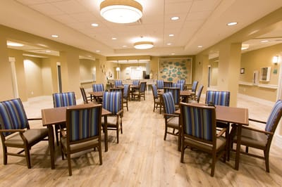 Bright and spacious common area with chairs and tables