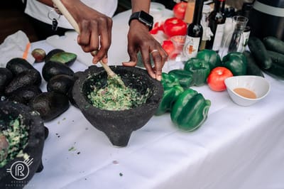 Hands mixing ingredients in a stone bowl