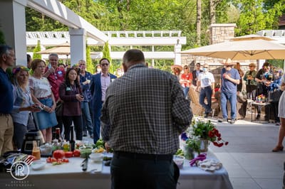 Outdoor event with people enjoying a cooking demonstration