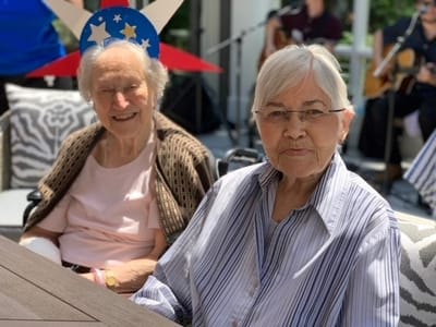 Two residents enjoying outdoor music entertainment