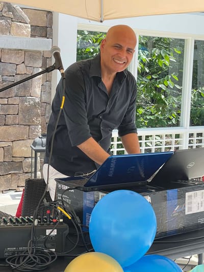 DJ entertaining at an outdoor event with balloons