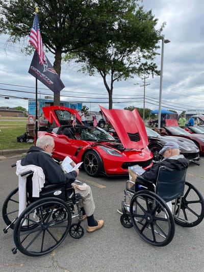 Residents enjoying a car show outdoors