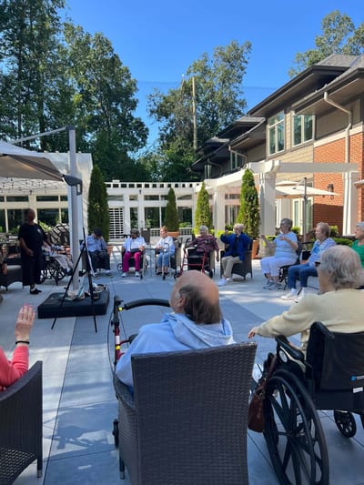Residents enjoying an outdoor activity in a garden space