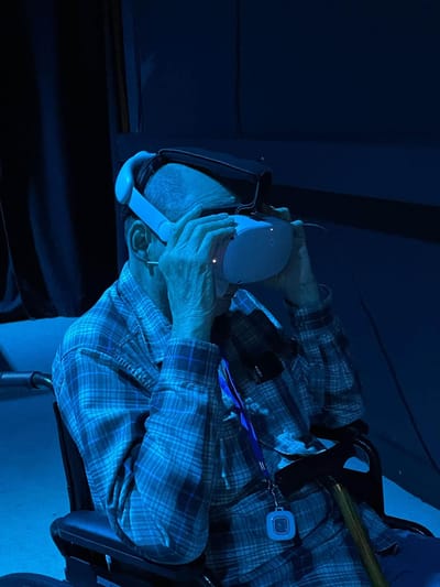 Resident using virtual reality headset in a dark room