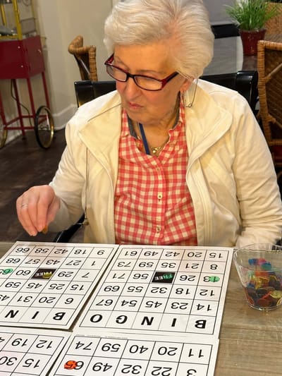 Resident playing bingo in an activity room
