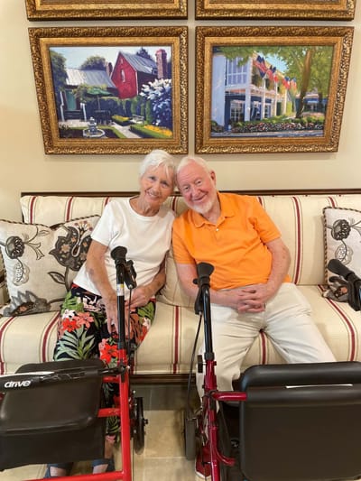 Two smiling residents in a common area