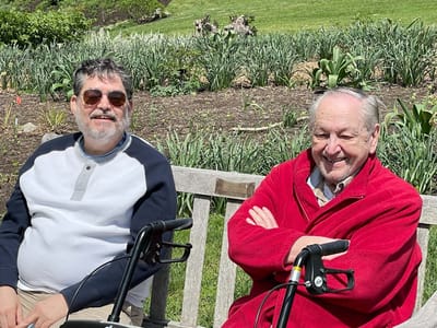 Two residents enjoying the garden on a sunny day
