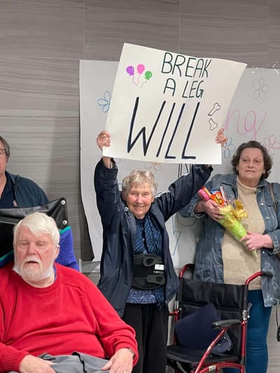 Residents celebrating with a sign at an event