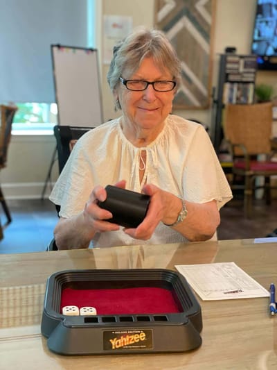 Resident playing Yahtzee in a common area