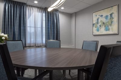 Interior of a meeting room with a round table and chairs