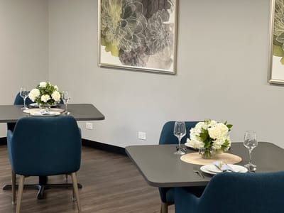 Dining area set for a meal with floral decorations