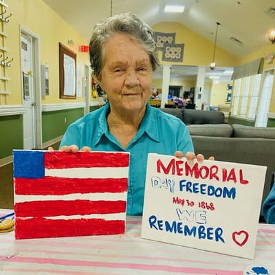 Resident showing a painted American flag and Memorial Day artwork