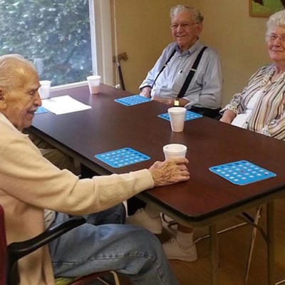 Residents playing a game at a table