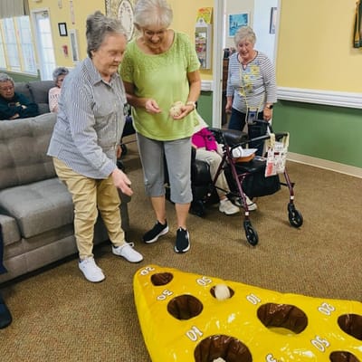 Residents engaged in a fun game activity indoors.